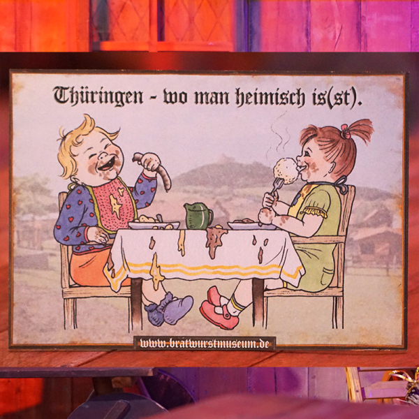 Lustiges Bratwurstspruch-Schild "Thüringen – wo man heimisch is(s)t"